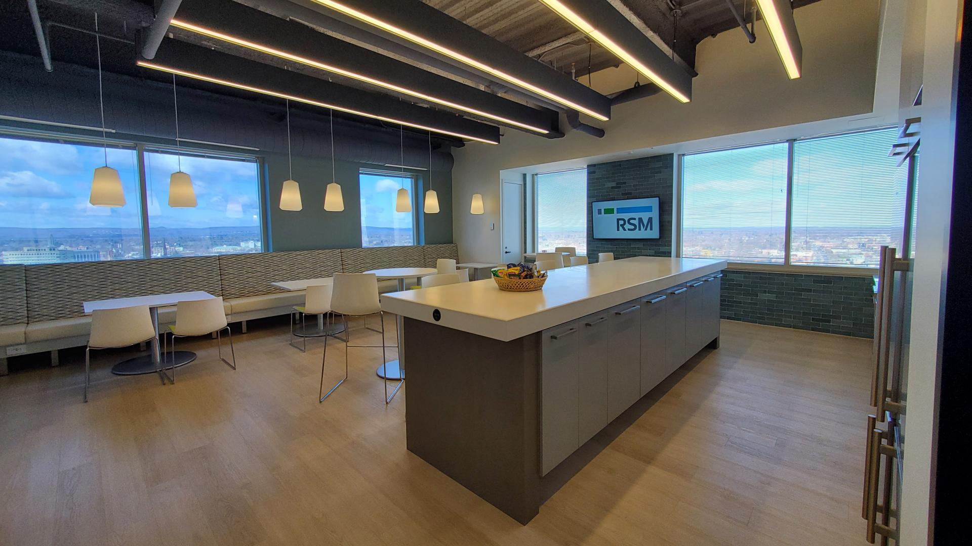 The breakroom takes full advantage of its corner location with wall-to-wall windows